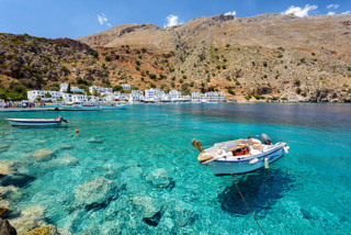 Small motorboat at clear water bay of Loutro town on Crete island, Greece